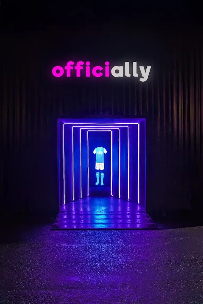 The outside of the CLTFC laser maze featuring the holographic jersey on display surrounded by lights